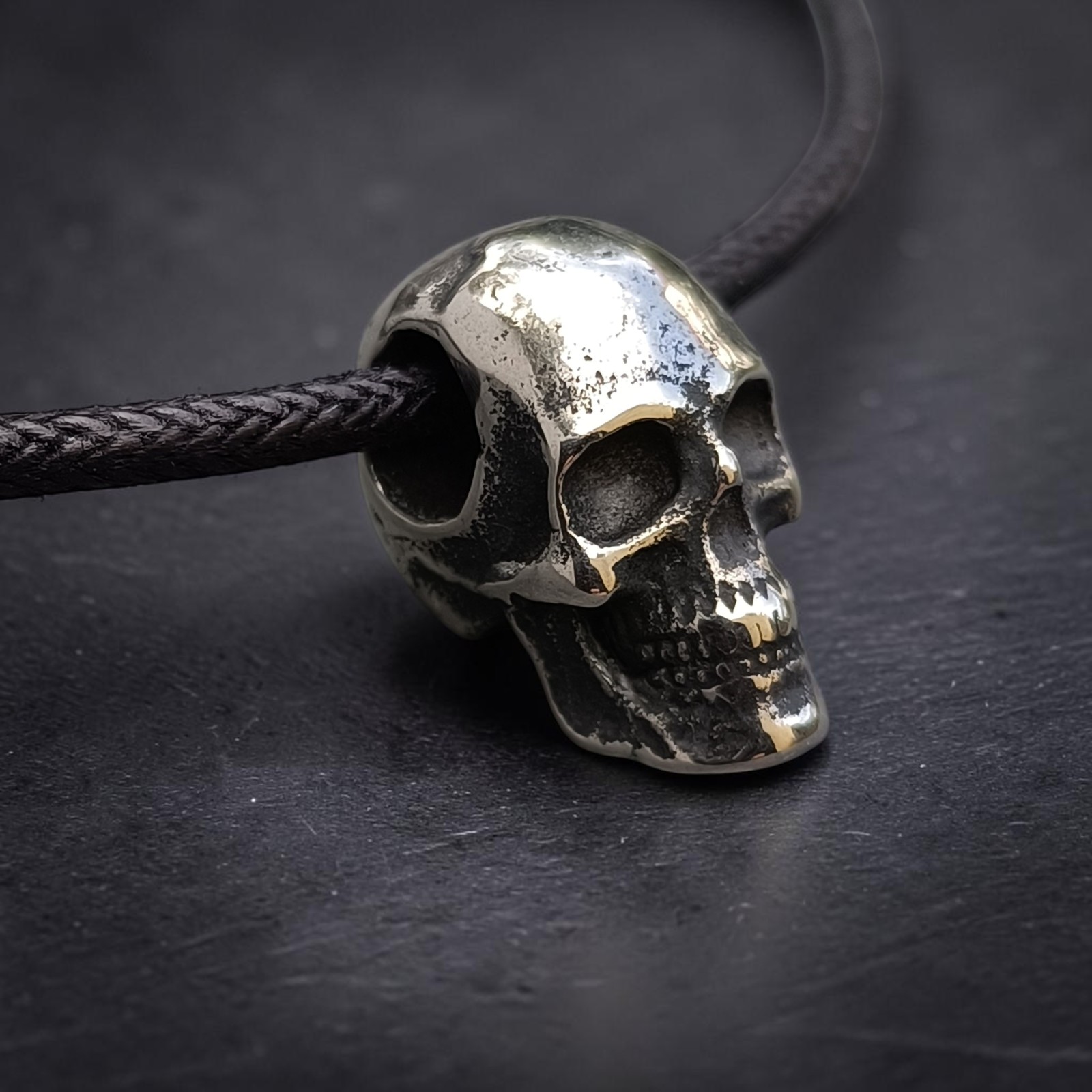 Edelstahl-Totenkopf in Nahaufnahme mit Augenhöhlen und Zahnreihe