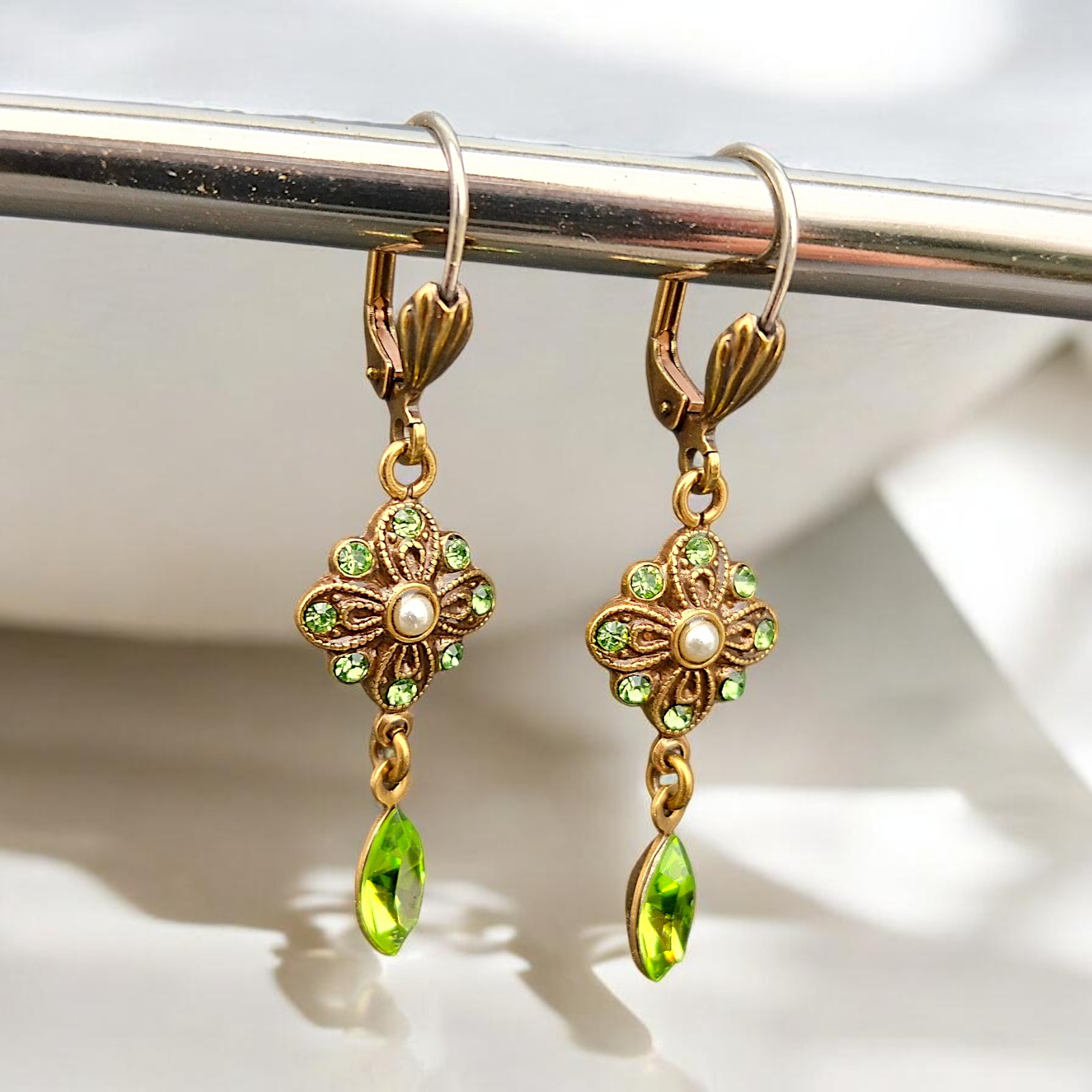 Goldfarbene Blüten-Ohrhänger mit hellgrünen Kristallen in Peridot und kleiner Perle